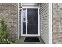 Dark brown front door with sidelights, a welcome mat, and brick facade at 2539 Shadowbrook Trce, Greenwood, IN 46143