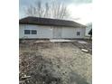 Home's backyard with a patio and unlandscaped yard at 2914 Rothe Ln, Indianapolis, IN 46229