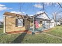 Front view of a brick ranch house with a covered porch at 308 E 36Th St, Anderson, IN 46013