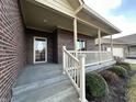 Inviting front porch with brick facade and white railing at 5375 E Commons West Dr, Mooresville, IN 46158