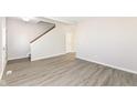 Open living area with gray walls and wood-look floors at 6927 Park Grove Blvd, Whitestown, IN 46075