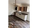 Kitchen with white cabinets, vinyl flooring, and a double sink at 8434 Meadowlark Dr, Indianapolis, IN 46226