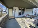 Inviting front porch with stonework and a porch swing at 102 N Munsie St, Indianapolis, IN 46229