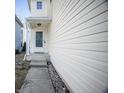 Townhome side view, showing a small porch and walkway at 1844 Misty Lake Dr, Indianapolis, IN 46260