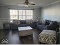 Spacious living room with gray sofas and wood floors at 4548 Copper Grove Dr, Indianapolis, IN 46237