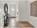 Bright entryway with hardwood floors, a console table, and a large mirror at 713 Penrose Pl, Danville, IN 46122