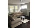 Living room featuring a fireplace, dark hardwood floors, and a beige couch at 749 W 32Nd St, Indianapolis, IN 46208