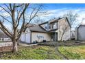 Tan two-story townhome with attached garage and green landscaping at 11517 Hidden Bay, Indianapolis, IN 46236