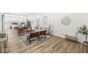 Open concept living area with hardwood floors, neutral decor, and a view into the kitchen at 305 Parkway Ave, Indianapolis, IN 46225
