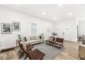 Bright living room with hardwood floors, comfy seating, and a view into the hallway at 305 Parkway Ave, Indianapolis, IN 46225