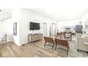 Open living space with hardwood floors, modern furniture, and a view into the kitchen at 305 Parkway Ave, Indianapolis, IN 46225