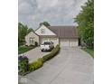 Brick home with three-car garage and manicured landscaping at 276 Carriage Ct, Franklin, IN 46131