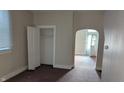 Empty bedroom with carpet, closet, and access to another room at 604 Lincoln St, Indianapolis, IN 46203