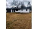 Newly renovated ranch home with white brick exterior, black accents, and a long driveway at 6805 E County Road 100 S, Avon, IN 46123