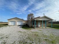 Tan house with attached garage and covered porch at 3088 N Alaska Rd, Cloverdale, IN 46120