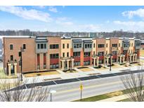 Aerial view of modern townhouses with brick and metal accents, located in a vibrant community at 376 S Meridian Unit A-Bldg C St, Greenwood, IN 46142