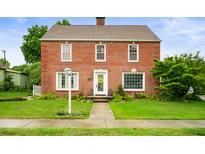 Brick two-story house with a landscaped lawn and walkway at 1011 N Woodward St, Lapel, IN 46051