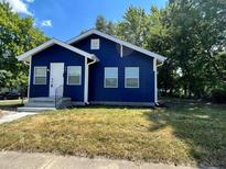Newly renovated blue house with a well-maintained lawn at 815 W 22Nd St, Anderson, IN 46016