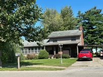 Ranch-style home with carport and well-maintained lawn at 643 Pratt St, Greenfield, IN 46140