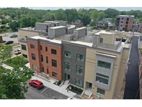 Modern townhouses with rooftop decks and parking. Red brick building in the center at 178 S Water # F, Franklin, IN 46131
