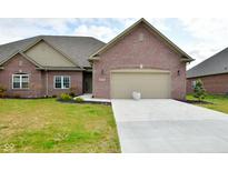 Brick ranch home with 2-car garage and landscaped lawn at 2749 Stones Bay Dr, Greenwood, IN 46143