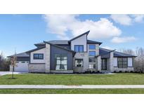 Modern two-story home with stone and siding accents, showcasing a stylish design at 9280 Highpointe Ln, Zionsville, IN 46077