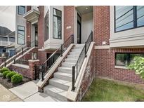 Modern brick townhouse exterior with a concrete staircase at 721 E 16Th St, Indianapolis, IN 46202