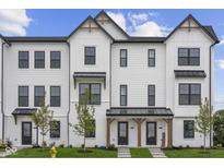 White two-story home with black accents and a welcoming front porch at 4541 Pennsy Way, Brownsburg, IN 46112