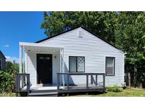 White house with black accents, covered porch, and deck at 3106 Newton Ave, Indianapolis, IN 46201