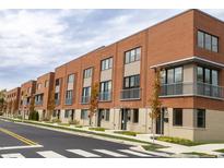 Modern brick townhouses with balconies and street view at 810 7Th St, Columbus, IN 47201