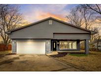 Newly renovated gray house with white garage door and landscaping at 6233 Lafayette Rd, Indianapolis, IN 46278