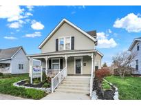 Quaint two-story house with a front porch and well-maintained lawn at 621 N State St, Greenfield, IN 46140