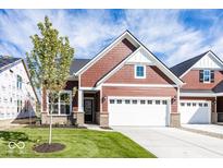 Craftsman style home with red siding, white trim, and a two-car garage at 3938 Holly Brook Dr, Westfield, IN 46074