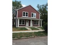 Two-story duplex with maroon siding and white trim at 217 N Temple Ave, Indianapolis, IN 46201