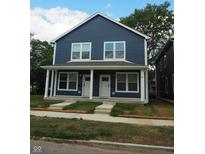 New construction duplex, featuring two units with navy siding and white trim at 221 N Temple Ave, Indianapolis, IN 46201