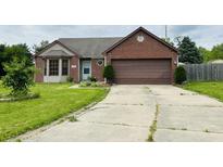 Brick ranch house with a brown garage door and a well-maintained lawn at 7020 Ira Ct, Indianapolis, IN 46217