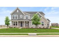 Two-story house with gray siding, stone accents, and a landscaped lawn at 15287 Garden Mist Pl, Fishers, IN 46037