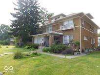 Two story home with a balcony and landscaping at 909 E 38Th St, Indianapolis, IN 46205