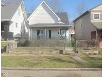 White house with front porch and chain link fence at 860 Udell St, Indianapolis, IN 46208