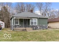 Charming ranch home with stone accents and mature trees at 3755 N Hawthorne Ln, Indianapolis, IN 46218