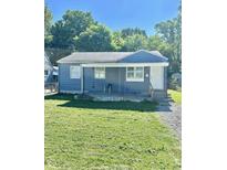 Ranch style home with blue siding, lawn, and small porch at 3521 N Riley Ave, Indianapolis, IN 46218