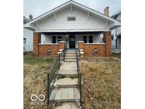 Charming craftsman home with brick details and porch at 57 N Tremont St, Indianapolis, IN 46222