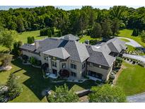 Luxury home with a large backyard, expansive lawn, and a stunning gray roof at 4023 Cedar Hills N Dr, Greenwood, IN 46143