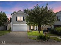 Two-story house with a white garage door and landscaped yard at 917 Balto Dr, Shelbyville, IN 46176