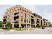 Modern brick building with balconies and street-level retail at 877 N East St # 104, Indianapolis, IN 46202