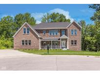 Brick two-story house with a large front yard at 372 Foxboro Cir, Avon, IN 46123