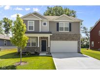 Two-story house with neutral siding, stone accents, and a two-car garage at 815 Stark St, Greenfield, IN 46140