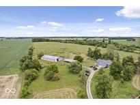 Aerial view of a house with large yard and outbuildings at 9996 N County Road 200 W, Muncie, IN 47302