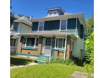 Two-story home with green and yellow siding at 3526 N Capitol Ave, Indianapolis, IN 46208