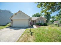 Brick ranch home with attached garage and landscaping at 3829 Chancellor Dr, Greenwood, IN 46143